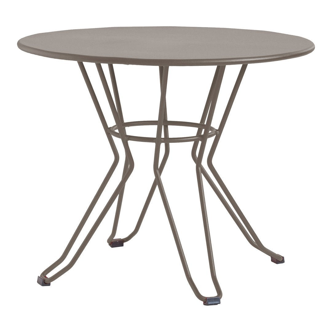 Round table in muted grey with a sleek, minimalist design and geometric wire base. Ideal for modern decor.