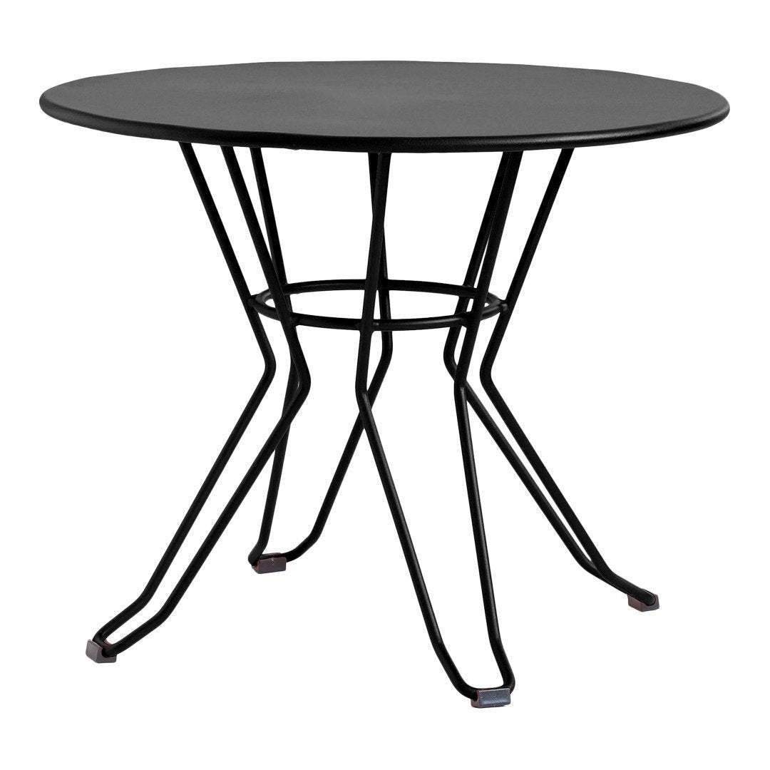 "Round black tabletop with sleek black metal legs, featuring a minimalist and modern design."