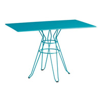 Turquoise rectangular table with a distinctive wire base, perfect for modern decor.