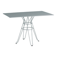 Rectangular table with a sleek white surface and a minimalist silver wire base, perfect for modern interiors.
