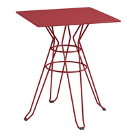 Red metal table with a geometric wire base, featuring a sleek, modern design and a vibrant matte finish.