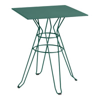 Green metal table with a geometric wire base and square top, perfect for modern outdoor or indoor decor.