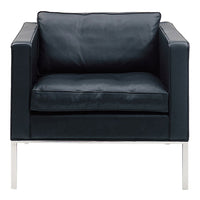 Black leather armchair with a sleek, minimalist design and chrome legs, perfect for modern interiors.