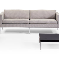 Gray striped sofa with clean lines and silver legs, paired with a sleek black coffee table. Perfect for modern decor.