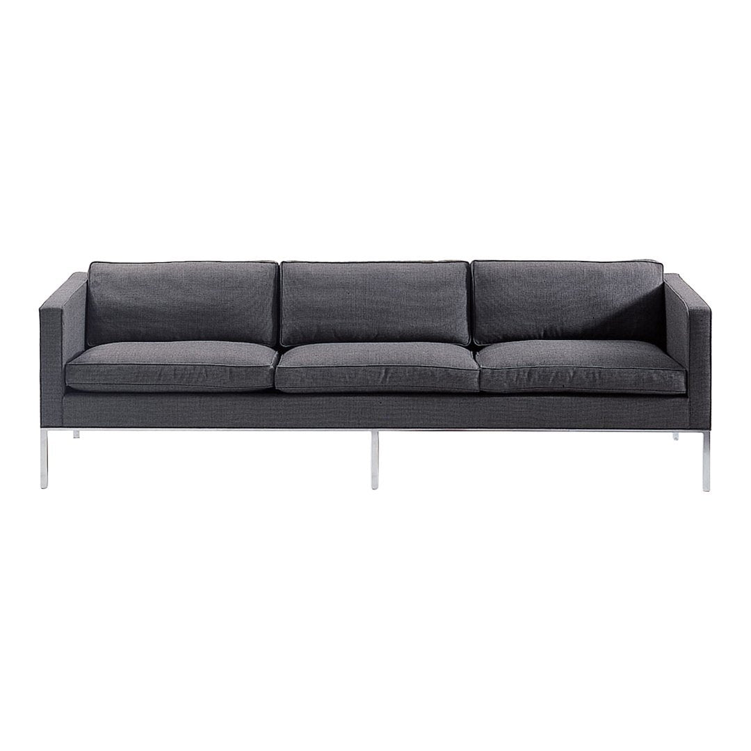 Gray upholstered sofa with a sleek, minimalist design and subtle textured pattern, featuring chrome legs.