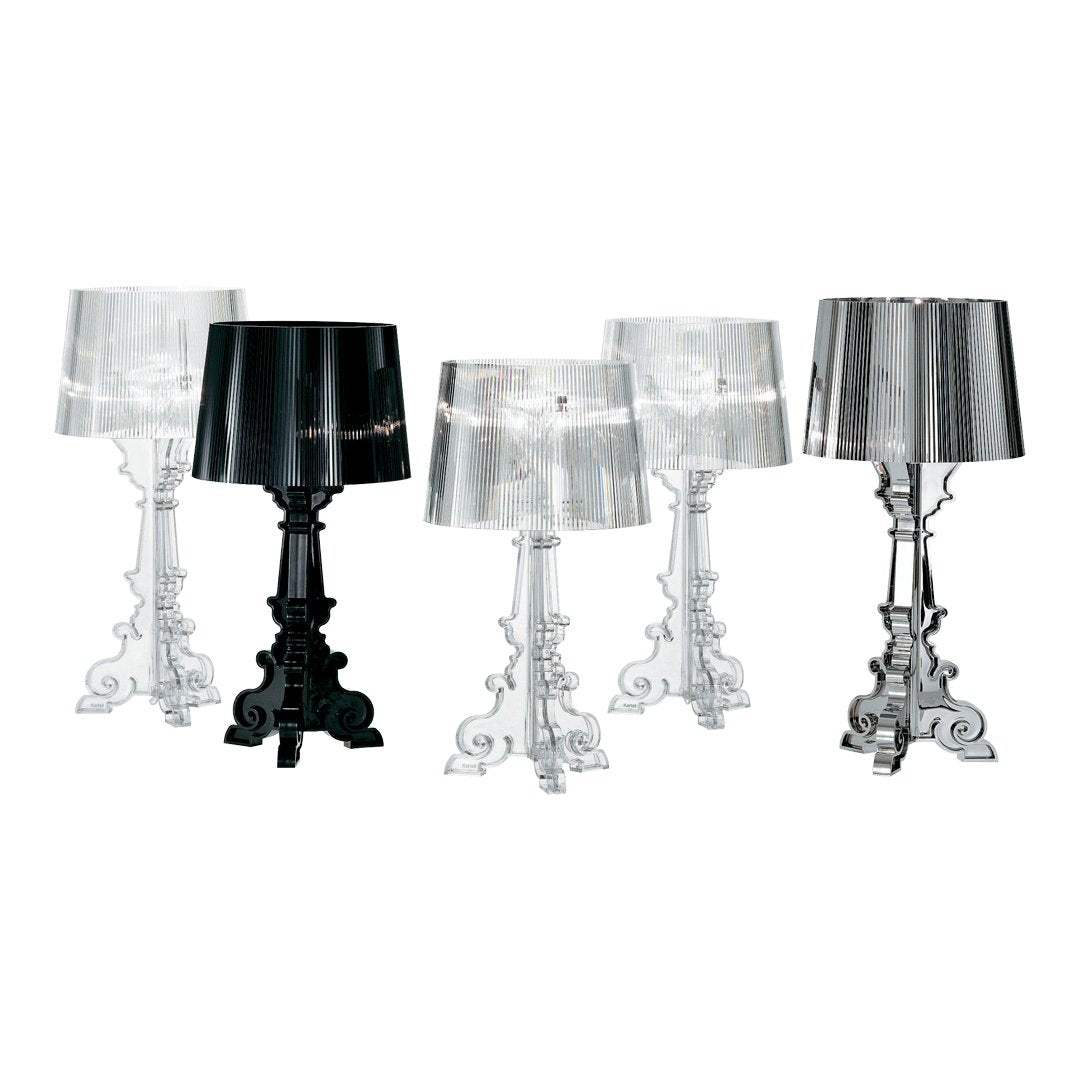 Elegant table lamps in clear, black, and silver finishes featuring intricate bases and sleek, modern shades.