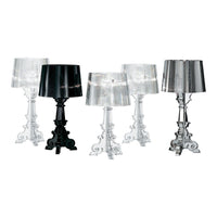 Elegant table lamps in clear, black, and silver finishes featuring intricate bases and sleek, modern shades.