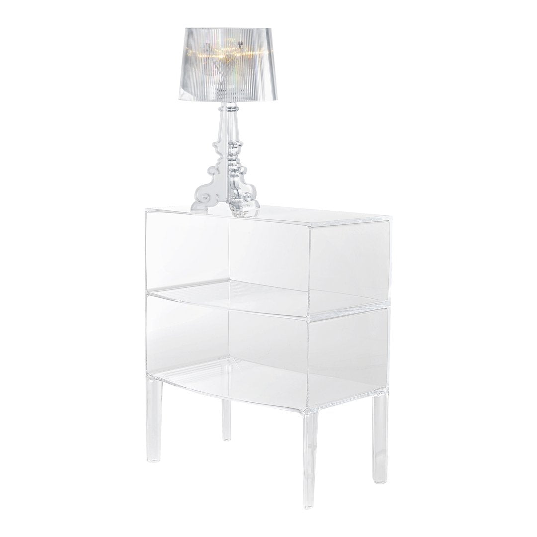 Clear acrylic nightstand with sleek, modern design and a stylish lamp, creating a minimalist aesthetic.