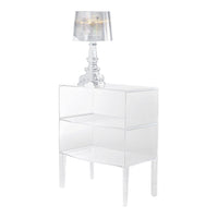 Clear acrylic nightstand with sleek, modern design and a stylish lamp, creating a minimalist aesthetic.