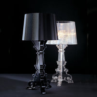 Black and transparent lamps with elegant patterns against a dark background, showcasing modern design.