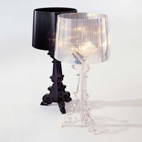 "Two stylish lamps: one in sleek black and the other in clear, featuring elegant ribbed shades."