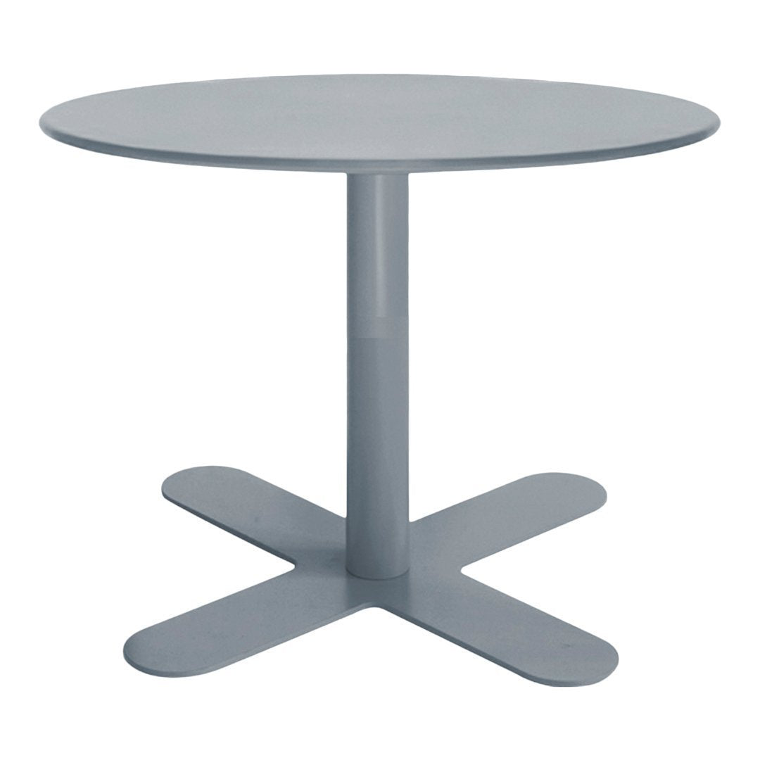 Round gray dining table with a smooth finish and a minimalist design featuring a sturdy cross-base.