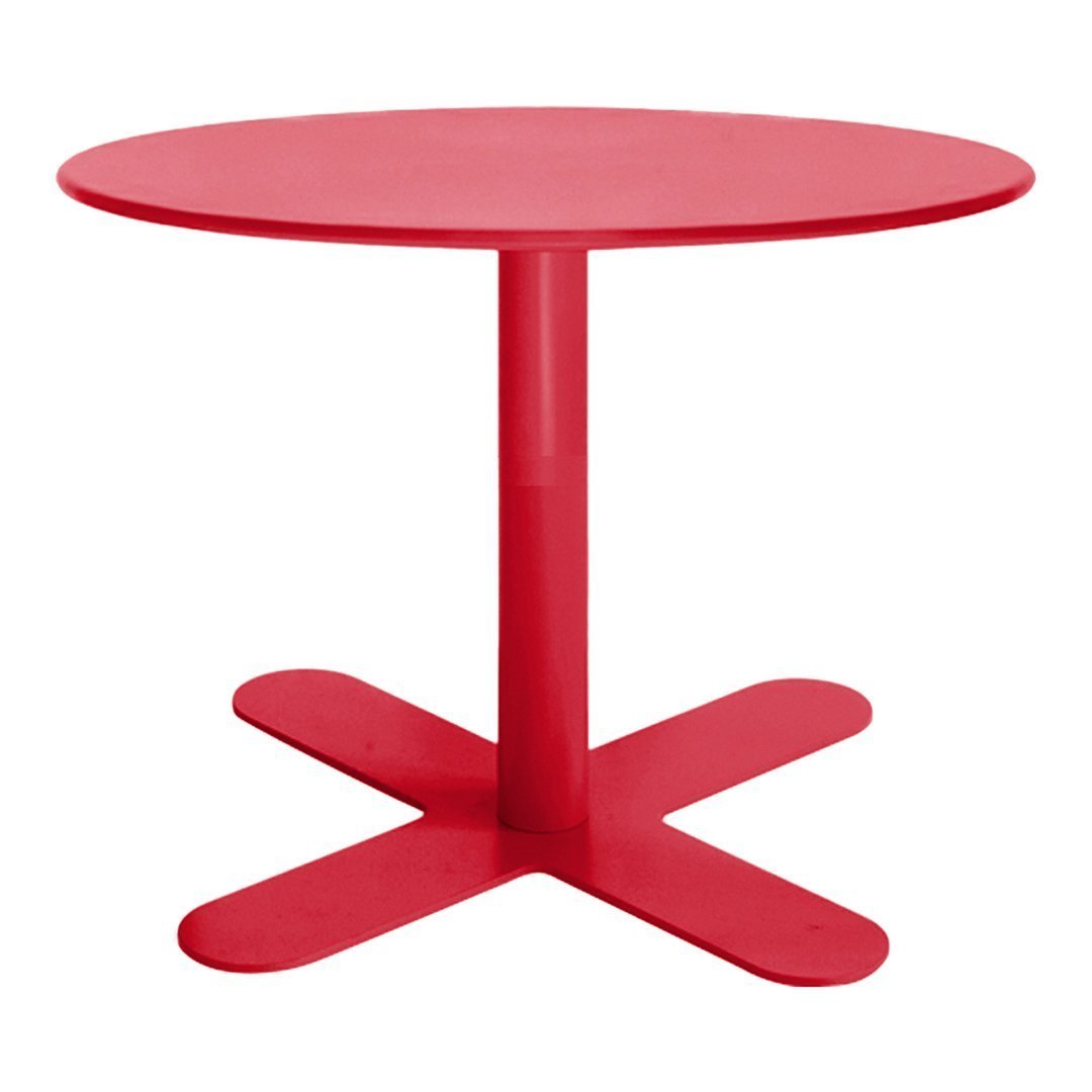 Round red table with a smooth, glossy finish and a minimalist design featuring a cross-shaped base.