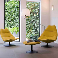 Yellow modern chairs with sleek lines, paired with a matching footrest in a minimalist indoor setting.