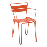 Vibrant orange metal chair with sleek lines and minimalist design, perfect for modern outdoor spaces.
