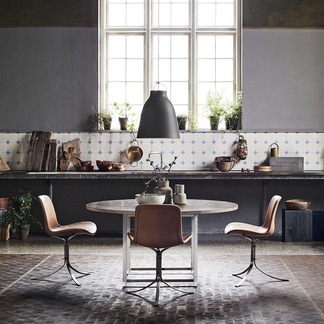 Modern kitchen featuring gray walls, patterned tiled backsplash, and earthy tones in furniture and decor.