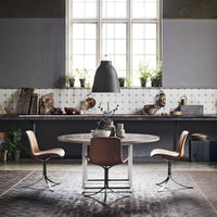Modern kitchen featuring gray walls, patterned tiled backsplash, and earthy tones in furniture and decor.