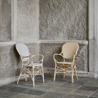 Blue and white chevron chair paired with a gold and white striped chair, showcasing stylish woven patterns.