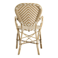 Rattan chair featuring a beige and white zigzag pattern, elegant and stylish for any space.