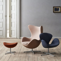 "Modern chairs in soft pink, deep navy, and warm brown with smooth curves, set against a minimalist interior."
