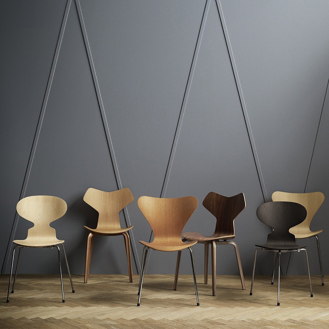 Five stylish chairs in natural wood tones: light blonde, warm honey, deep brown, with smooth, curved designs.