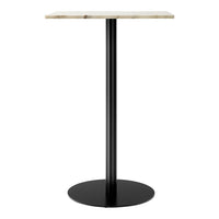 Modern table with a sleek black base and a textured light-colored top. Ideal for contemporary decor.