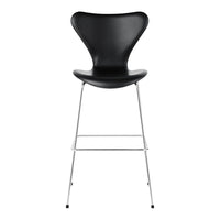 Black modern bar stool with a sleek, curved design and chrome legs. Ideal for contemporary spaces.