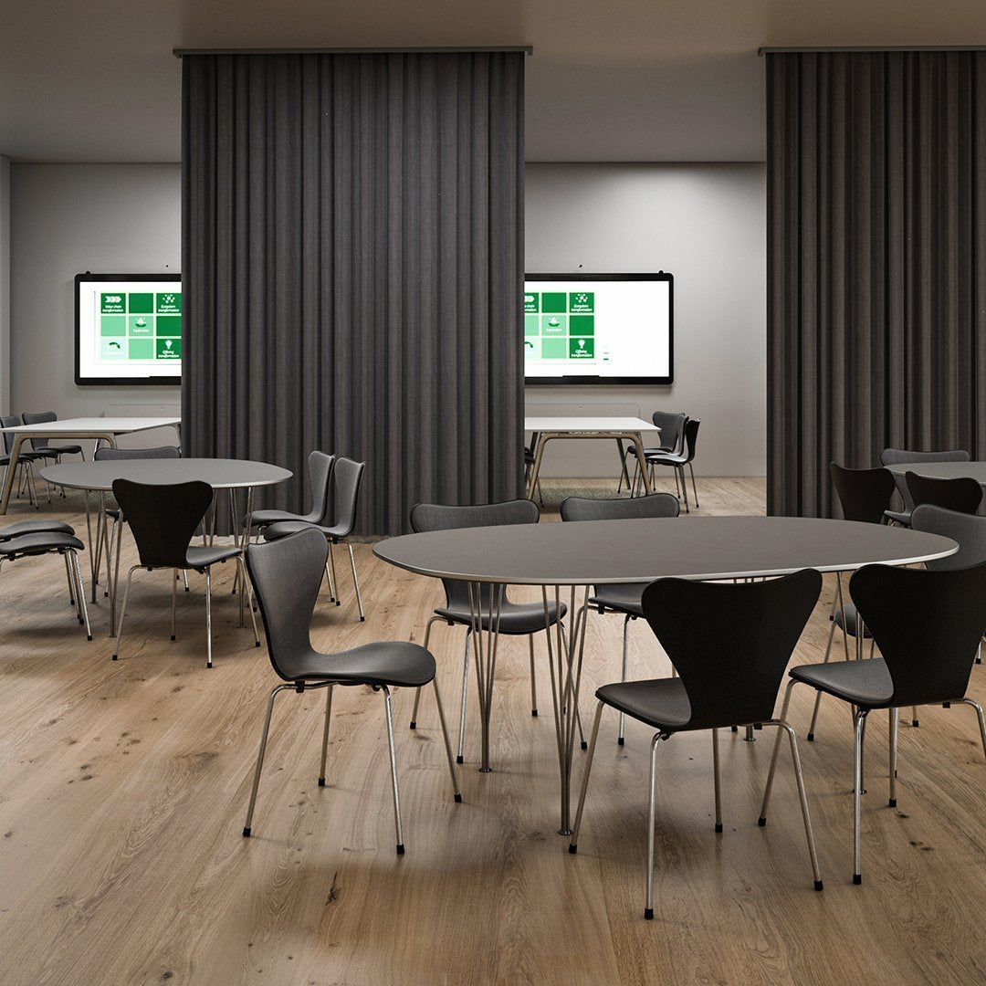 Modern dining area featuring sleek black chairs, round gray tables, and warm wooden flooring. Minimalist design aesthetics.