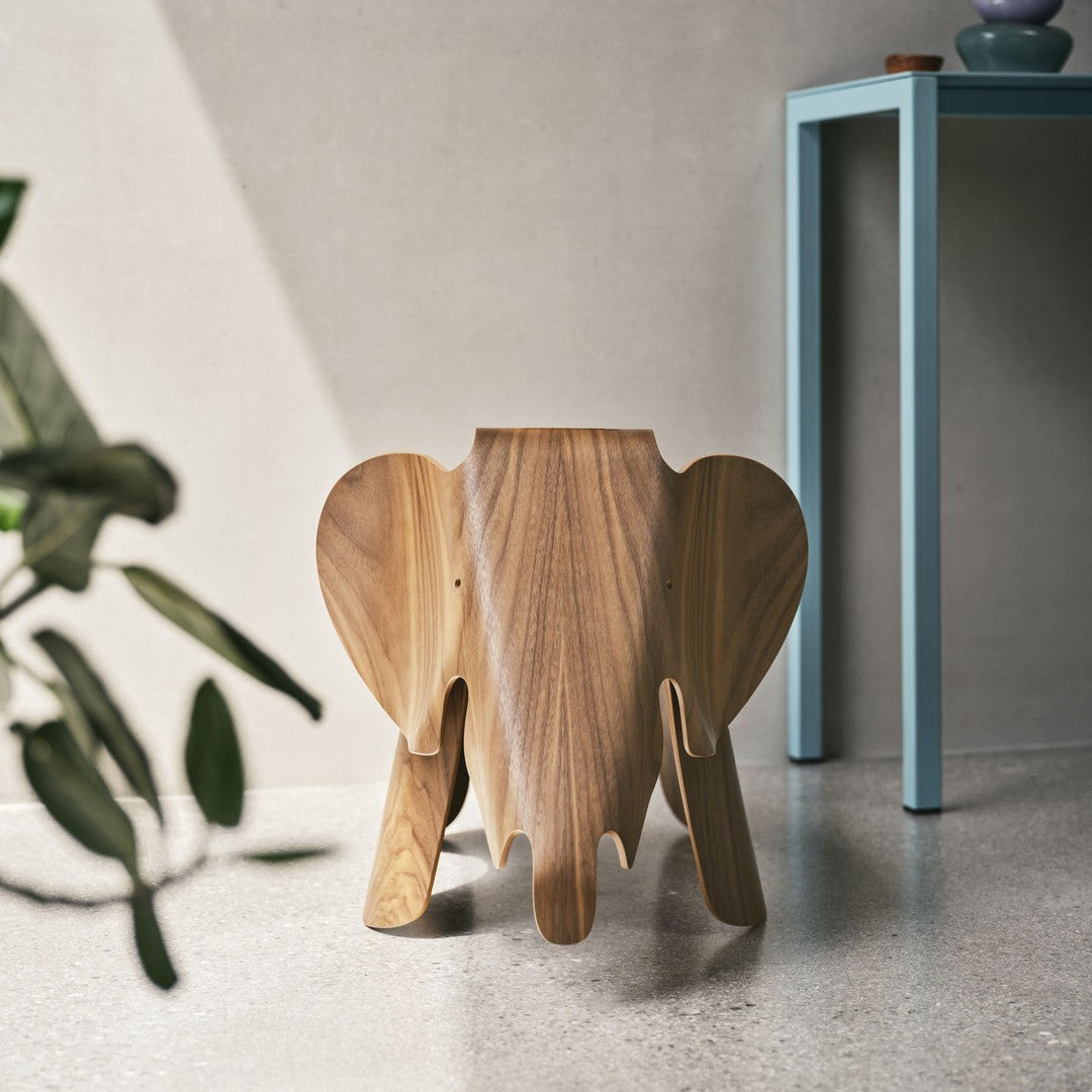 Wooden elephant-shaped stool with natural wood tones, smooth finish, and unique detailing. Perfect for playful decor.
