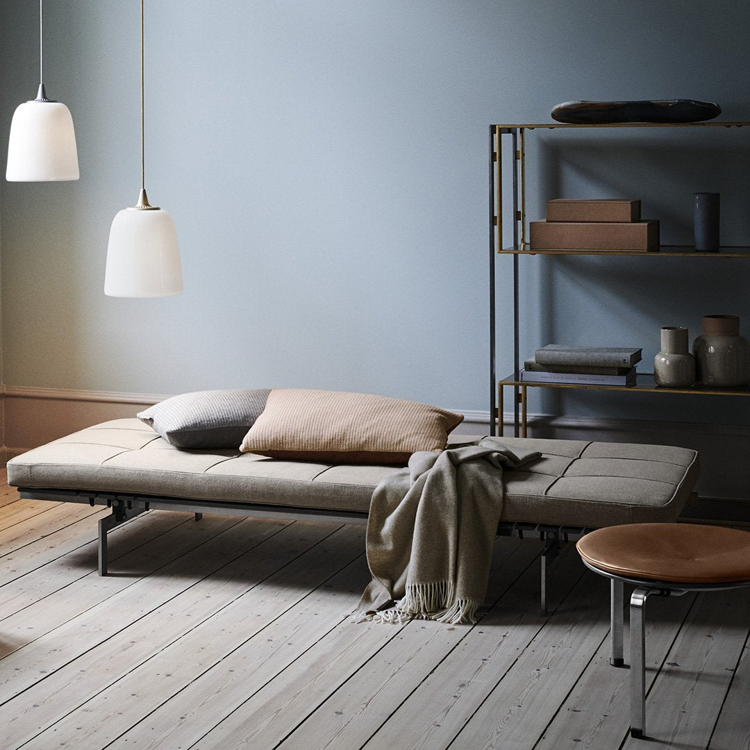 Tranquil room with soft blue walls, beige and brown accents, natural wood floors, and minimalist decor.