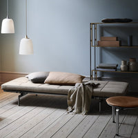 Tranquil room with soft blue walls, beige and brown accents, natural wood floors, and minimalist decor.