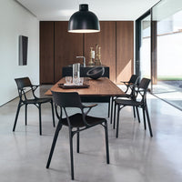 Modern black dining chairs with a sleek design paired with a warm wooden table in a contemporary setting.