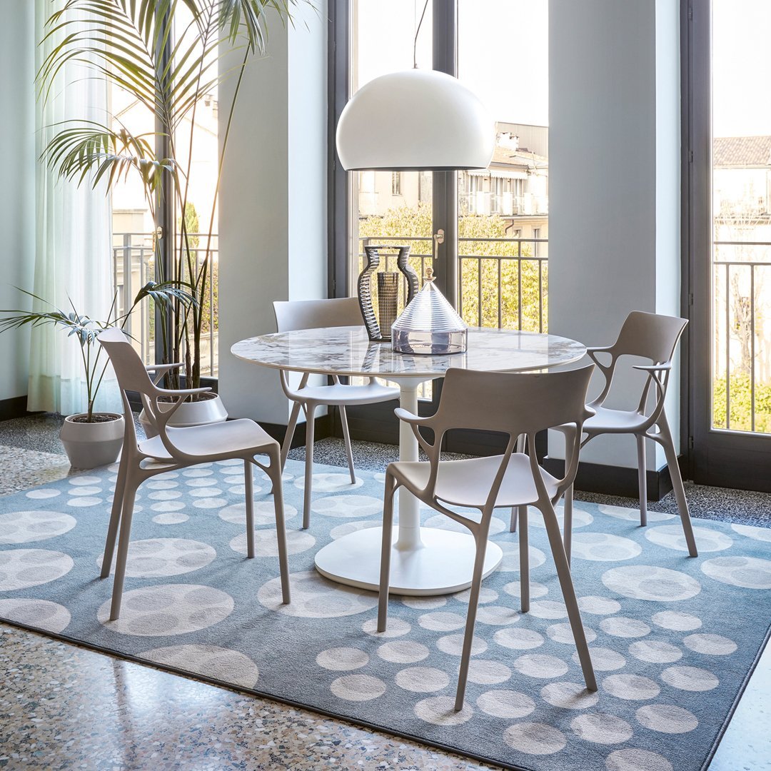 Colorful patterned tiles in a mosaic design, featuring shades of blue, purple, yellow, and white, set in a bright balcony.
