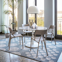 Colorful patterned tiles in a mosaic design, featuring shades of blue, purple, yellow, and white, set in a bright balcony.