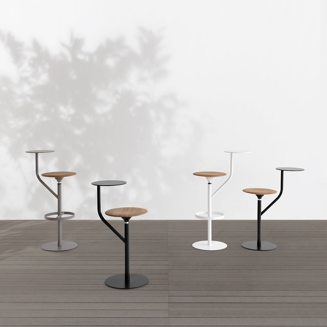"Stylish bar stools in black, white, and gray with natural wood accents, featuring modern minimalist design."