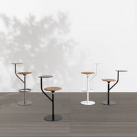 "Stylish bar stools in black, white, and gray with natural wood accents, featuring modern minimalist design."