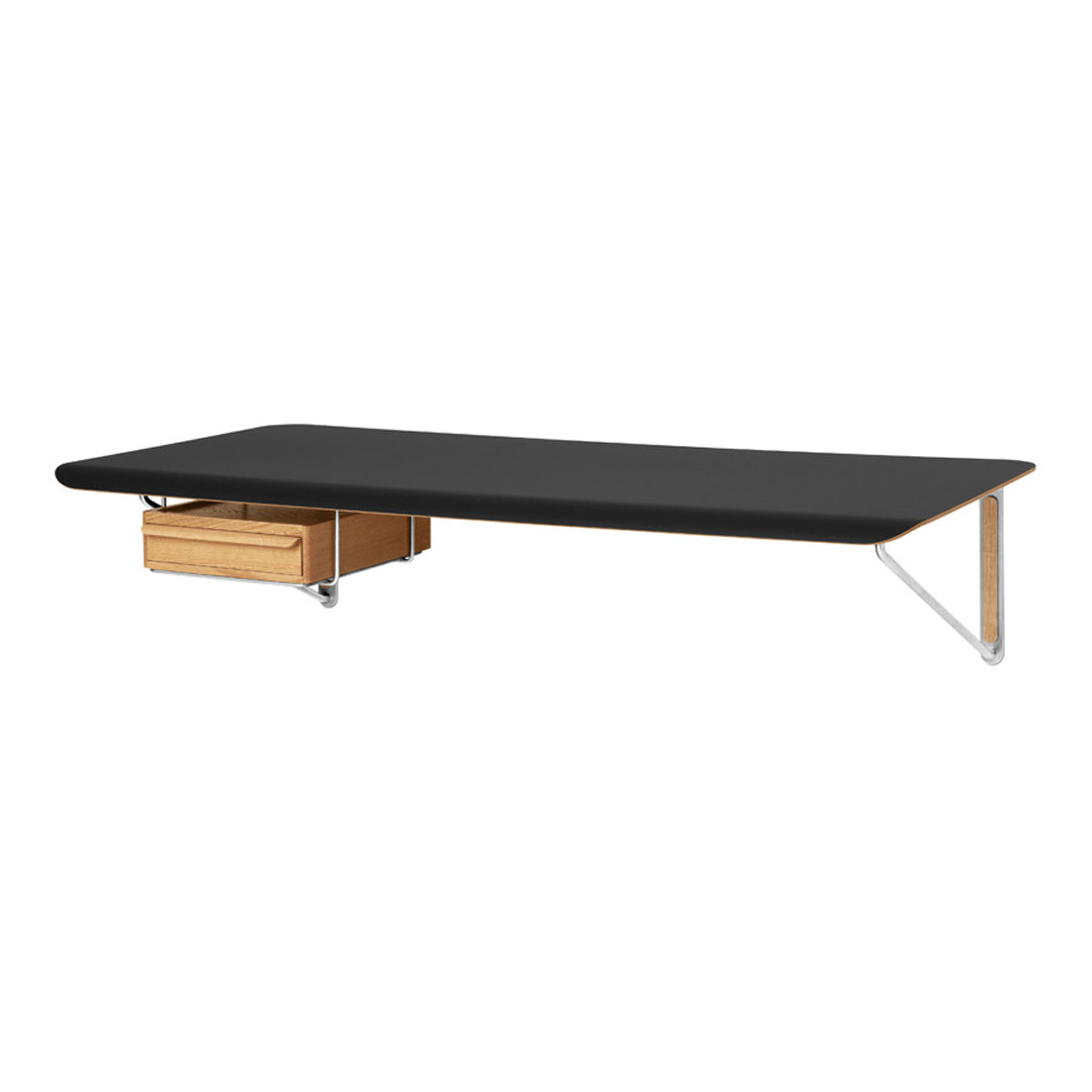 Modern black tabletop with natural wood drawer and sleek metal legs, perfect for contemporary interiors.