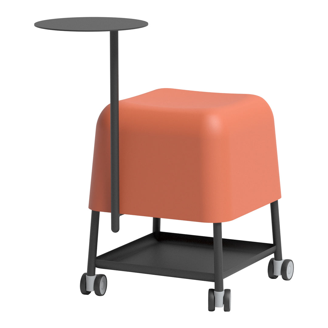 Coral-colored cube with a black metal side table and wheels, featuring a minimalist design and smooth surfaces.