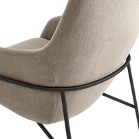 Beige upholstered chair with a smooth texture and sleek black metal frame for a modern look.