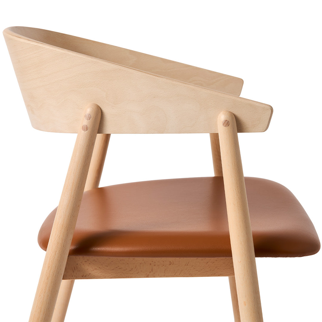 Light natural wood chair with a sleek light tan leather seat, featuring smooth curves and clean lines.