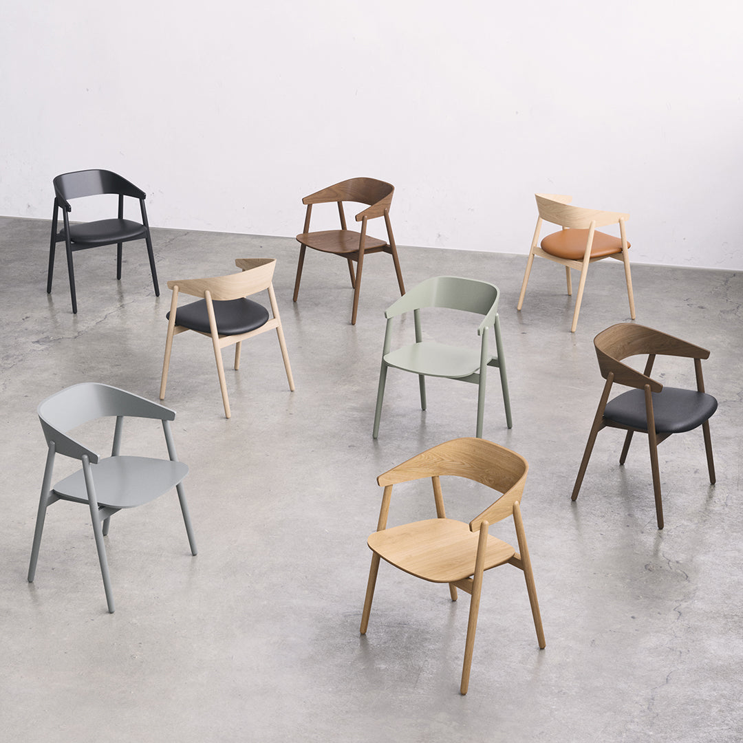 Colorful array of modern chairs in black, gray, green, beige, brown, and orange wood tones and sleek designs.