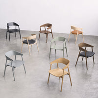 Colorful array of modern chairs in black, gray, green, beige, brown, and orange wood tones and sleek designs.