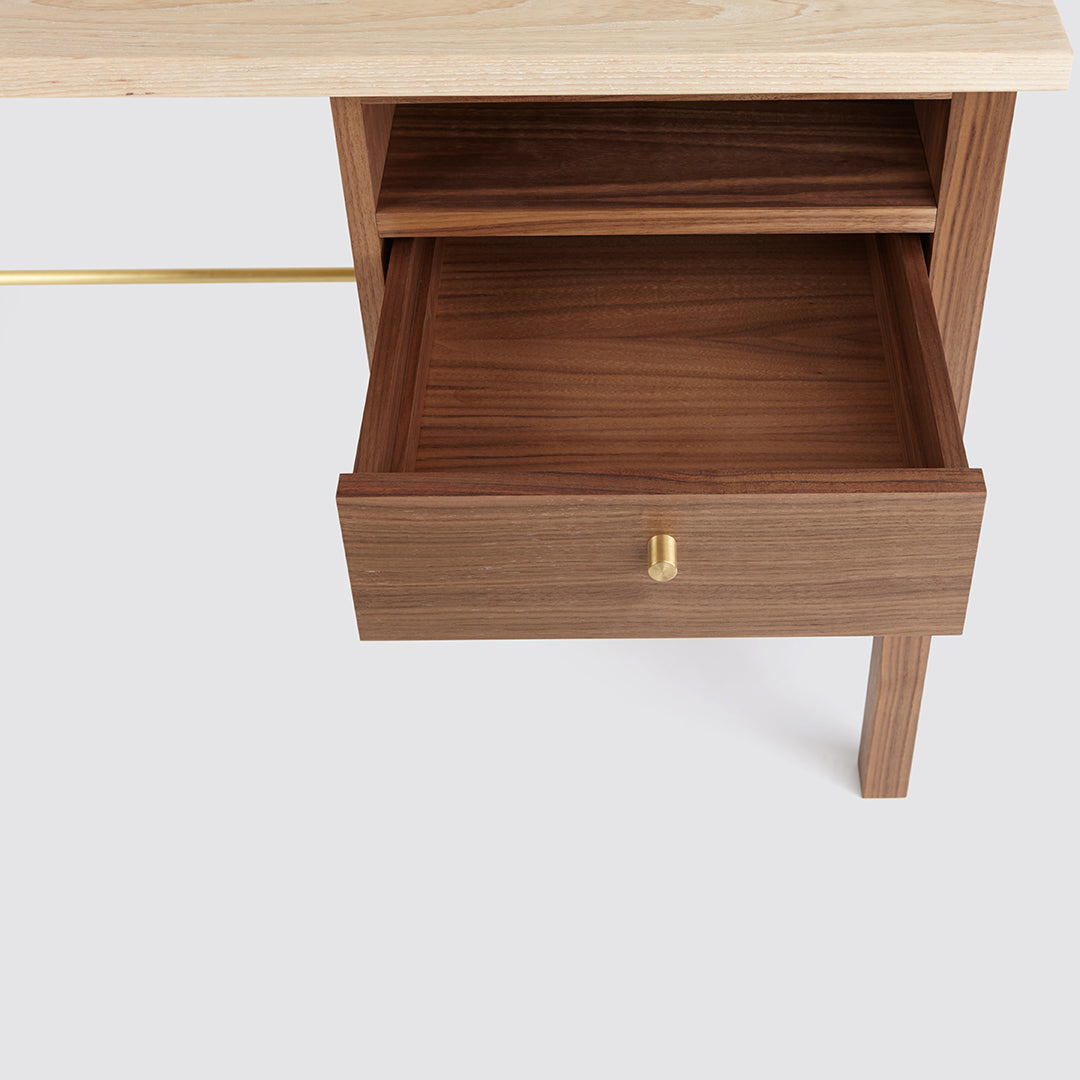 Light wood top with a sleek walnut drawer and gold handle, showcasing a modern, minimalist design.