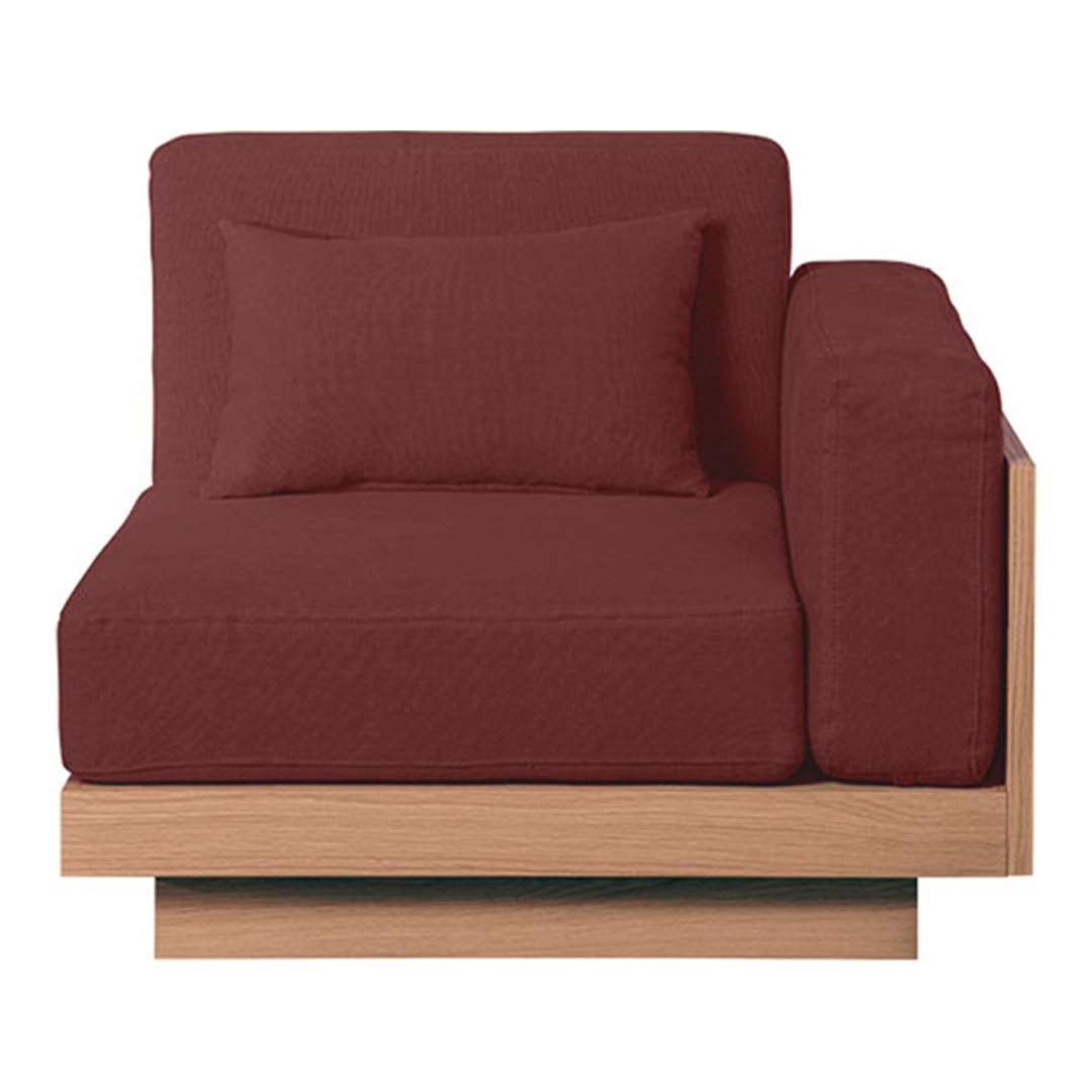 Burgundy upholstered armchair with a wood base, featuring a solid texture and matching decorative pillow.
