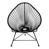 Black Acapulco chair with a distinctive pattern of vertical and curved lines, featuring a sleek, modern design.