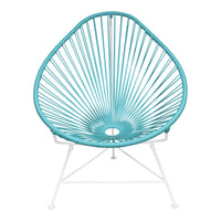 Turquoise Acapulco chair with a unique, concentric pattern and white metal legs, perfect for stylish outdoor seating.