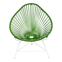 Vibrant green Acapulco chair with a geometric sunburst pattern and white metal legs, perfect for modern outdoor decor.