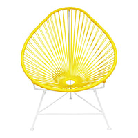 Bright yellow Acapulco chair with a geometric pattern and white metal legs, perfect for modern indoor or outdoor decor.