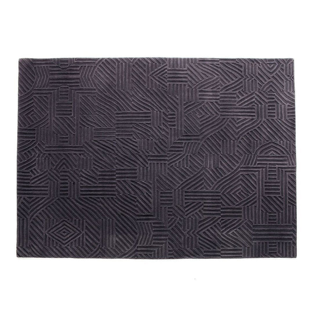 "Textured black area rug with intricate geometric pattern and raised lines."