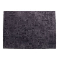 "Textured black area rug with intricate geometric pattern and raised lines."